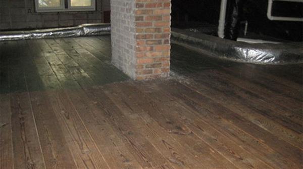 The attic floor prior to weatherization. The ducts were insulated only by a thin layer of fiberglass.