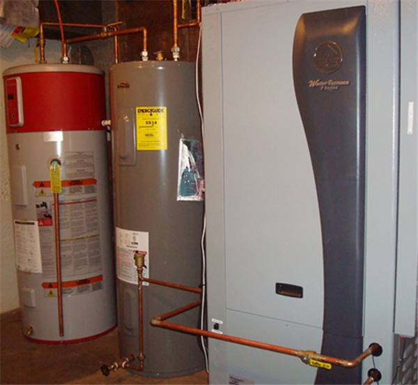 The Water Furnace 7 Series heat pump, the heart of the geothermal system. Also shown are the preheat tank (gray) and the water heater (white and red), which are discussed below. 